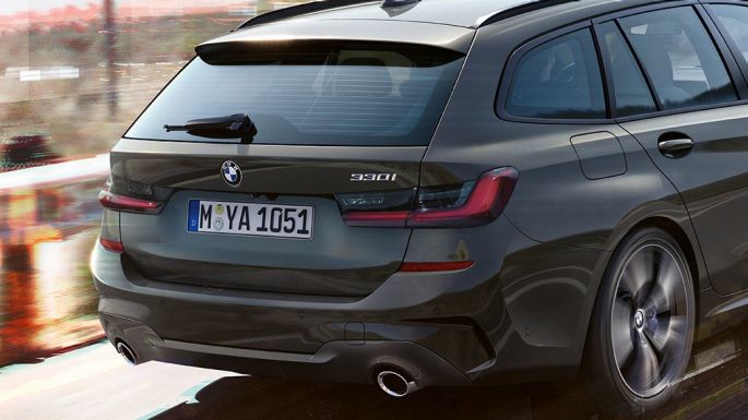 BMW 3 Reeks Touring, driekwart achteraanzicht G21 BMW 3 Reeks Touring, driekwart achteraanzicht tijdens het rijden op een brug in een landelijke omgeving G21