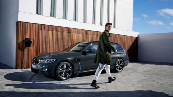 Plug-in-hybride BMW 3 Reeks Touring 2021 G21 driekwart zijaanzicht ladend Plug-in-hybride BMW 3 Reeks Touring 2021 G21 driekwart zijaanzicht ladend met model