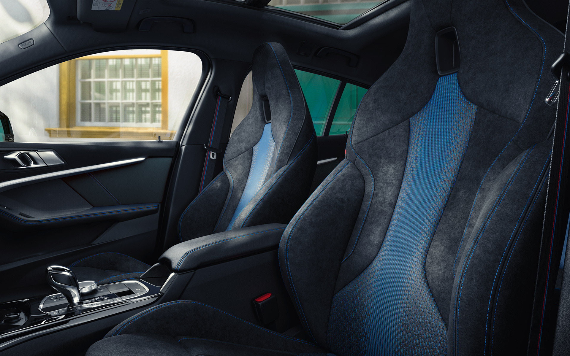 BMW 1 Reeks F40 M sportzetels Ergonomisch gevormde M sportzetels in de BMW 1 Reeks F40 met blauwe contrastnaad en geïntegreerde hoofdsteun