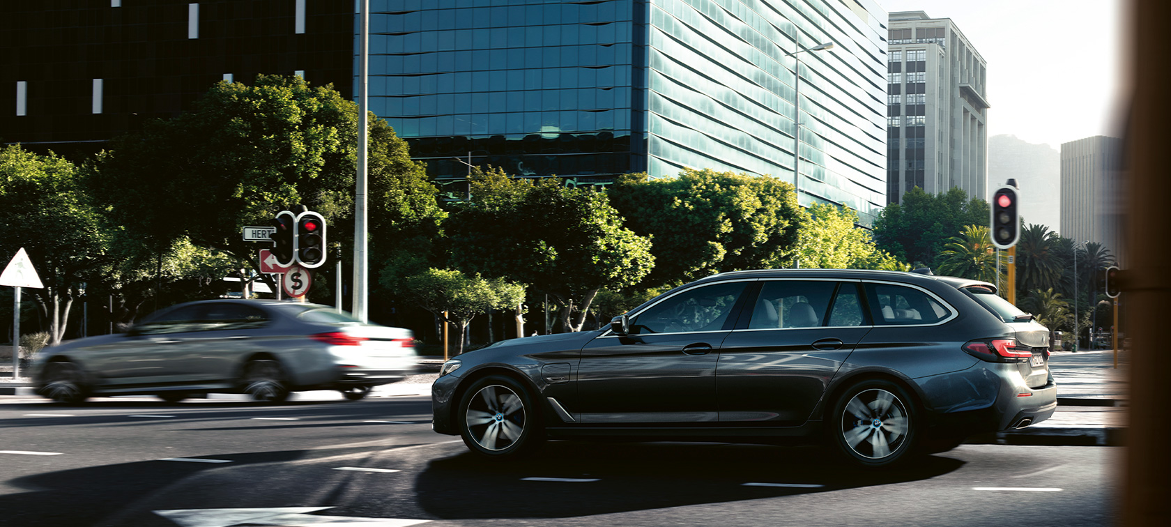 La BMW Série 5 Touring G31 en action BMW Série 5 Touring G31 restylage 2020 Sophistograu, vue de profil en mouvement dans un paysage urbain