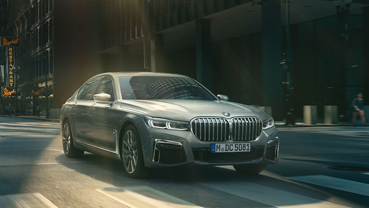 Driving Assistant Pack Professional: driekwart vooraanzicht van de rijdende BMW 7 Reeks in een stedelijke omgeving BMW 7 Reeks Driving Assistant Pack Professional