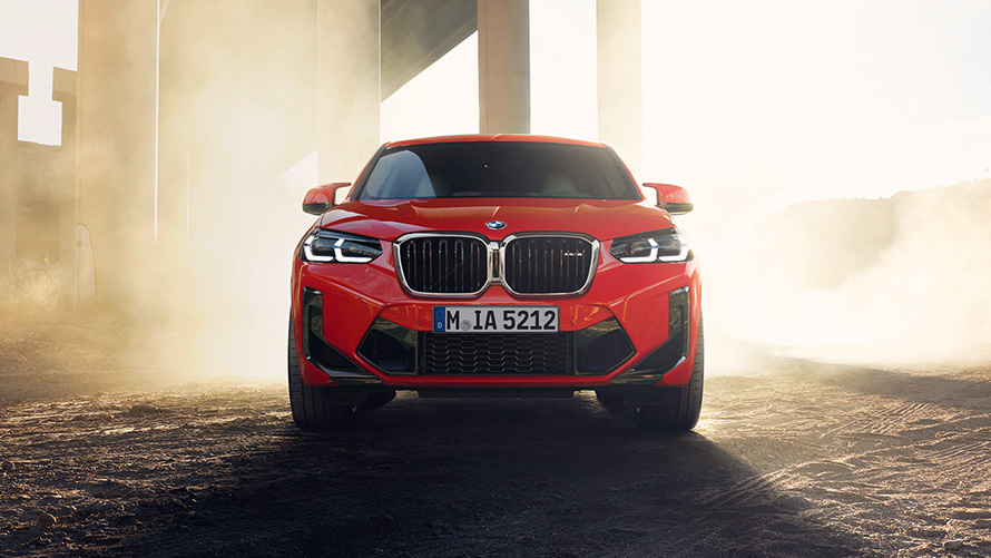 BMW X4 M F98 LCI Facelift 2021 Toronto Rot metallic vue de face devant les colonnes d'un pont