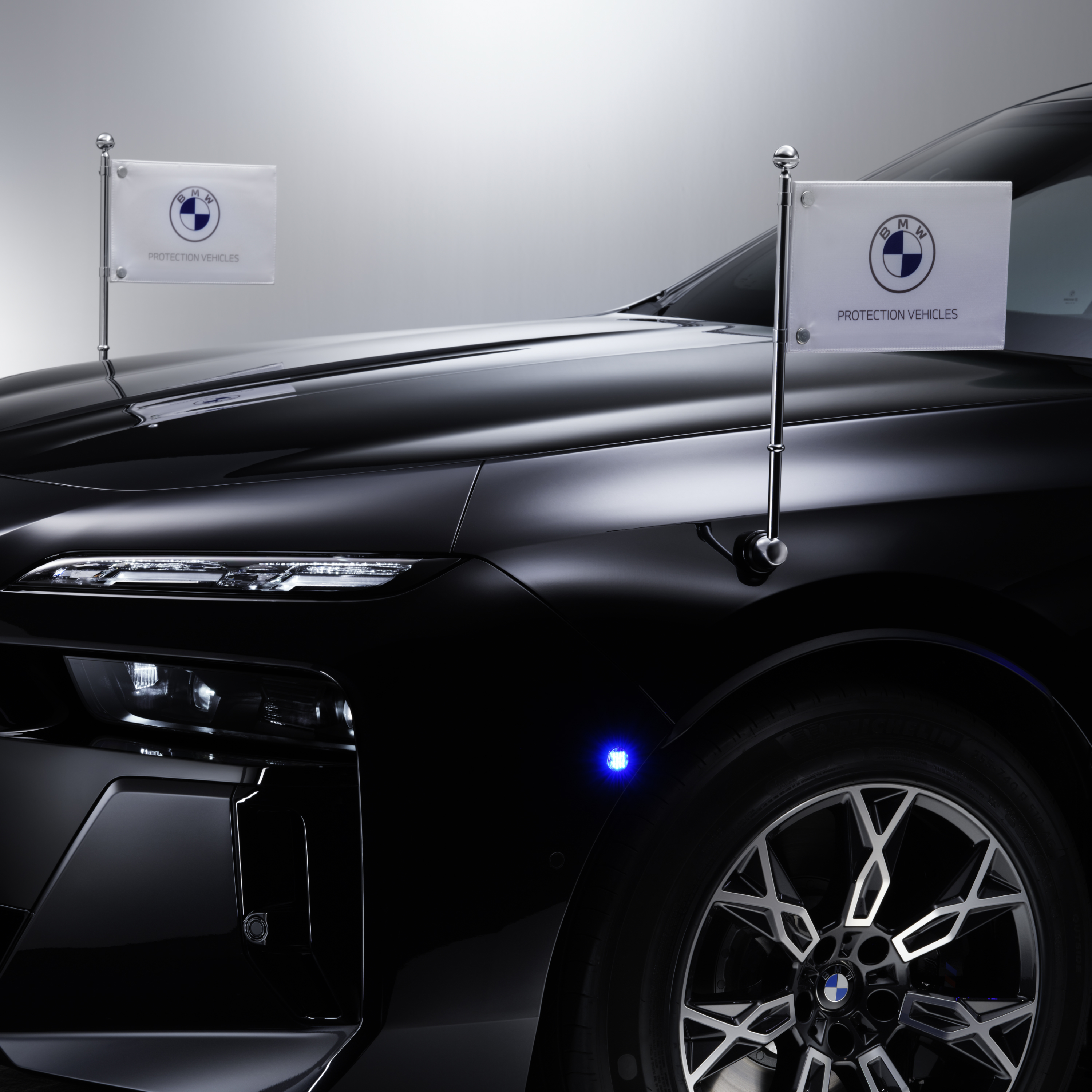 Detailweergave van een BMW met twee vlaghouders vooraan